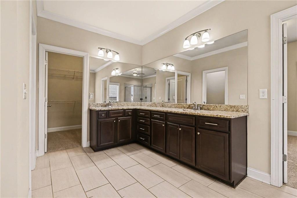 2960 Hampton Grv Trace Dacula, GA 30019 - Photo 27 of 33 a large bathroom with a sink a large mirror and a shower