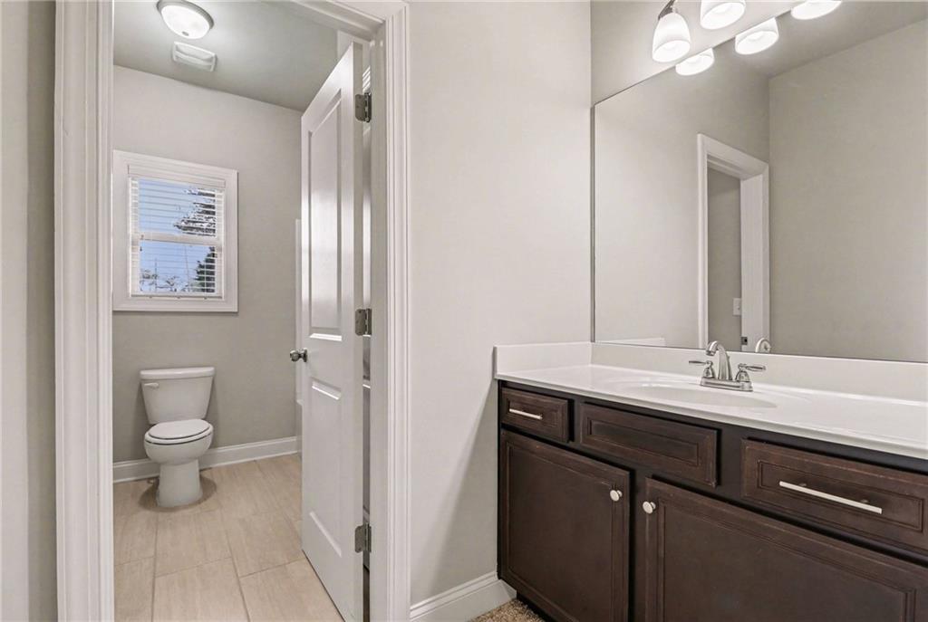 2960 Hampton Grv Trace Dacula, GA 30019 - Photo 28 of 33 a bathroom with a sink a toilet and a mirror