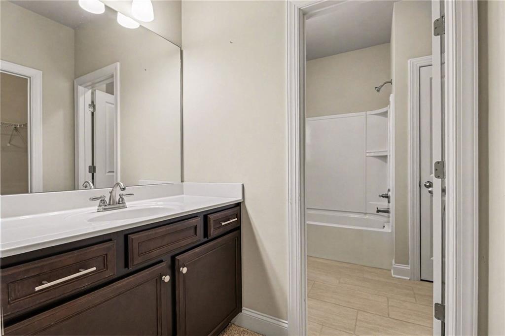 2960 Hampton Grv Trace Dacula, GA 30019 - Photo 29 of 33 a bathroom with a sink and a mirror