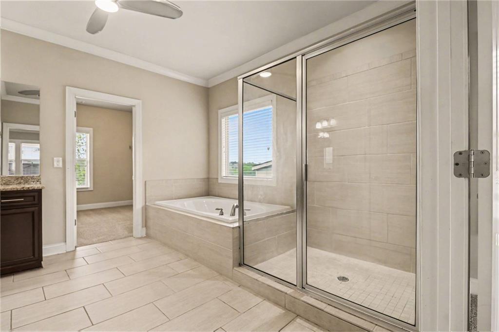 2960 Hampton Grv Trace Dacula, GA 30019 - Photo 30 of 33 a bathroom with a bathtub and a shower
