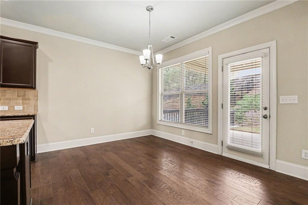 2960 Hampton Grv Trace Dacula, GA 30019 - Photo 9 of 33 a view of livingroom with window wooden floor and chandelier