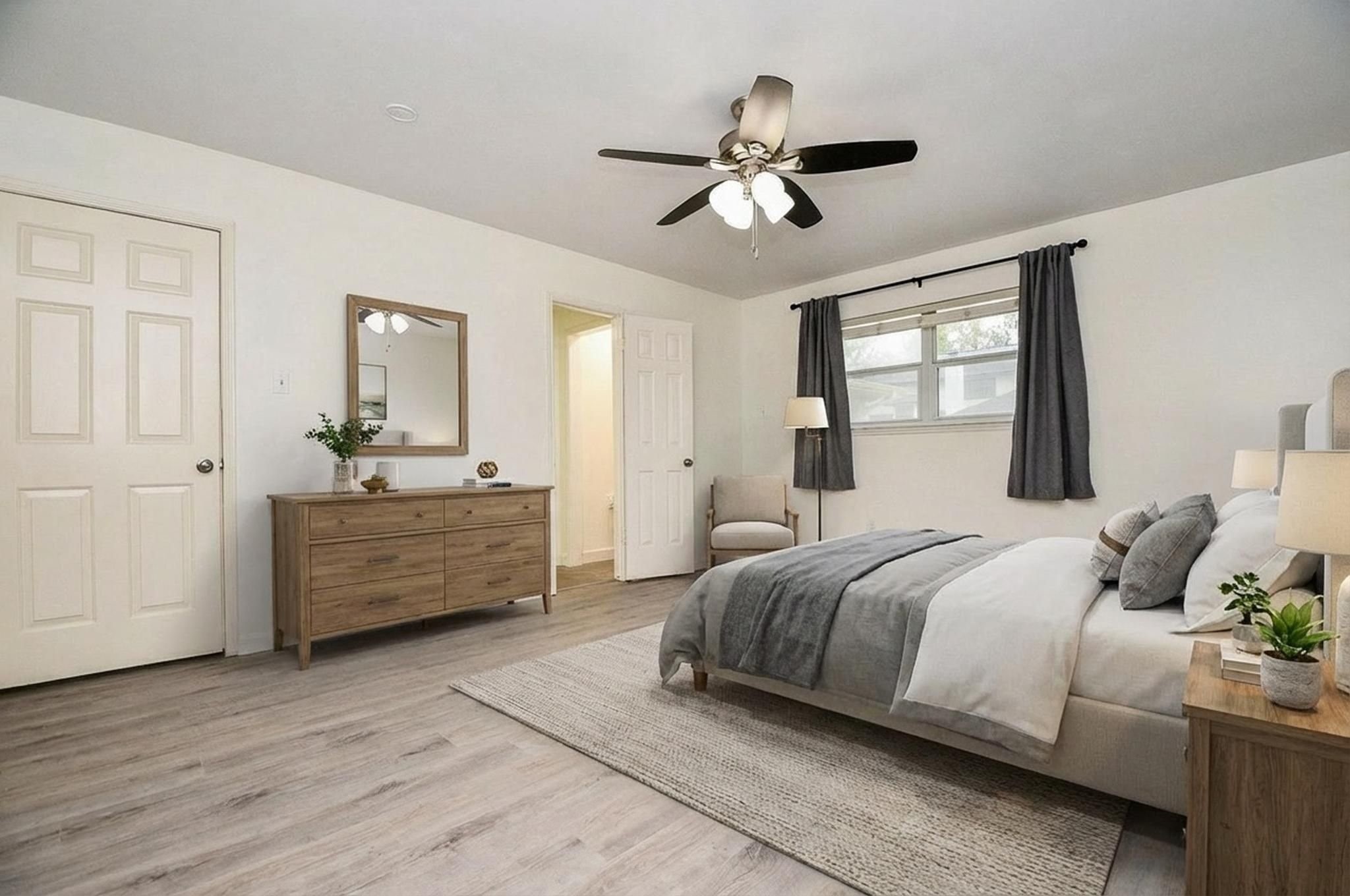 14011 Wickersham Lane Houston, TX 77077 - Photo 20 of 38 The primary bedroom suite overlooks the backyard and is complete with a freshly remodeled bathroom and large walk-in closet. Virtual rendering to illustrate the size and layout flexibility of this room.