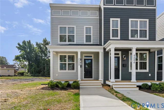 front view of a brick house with a yard
