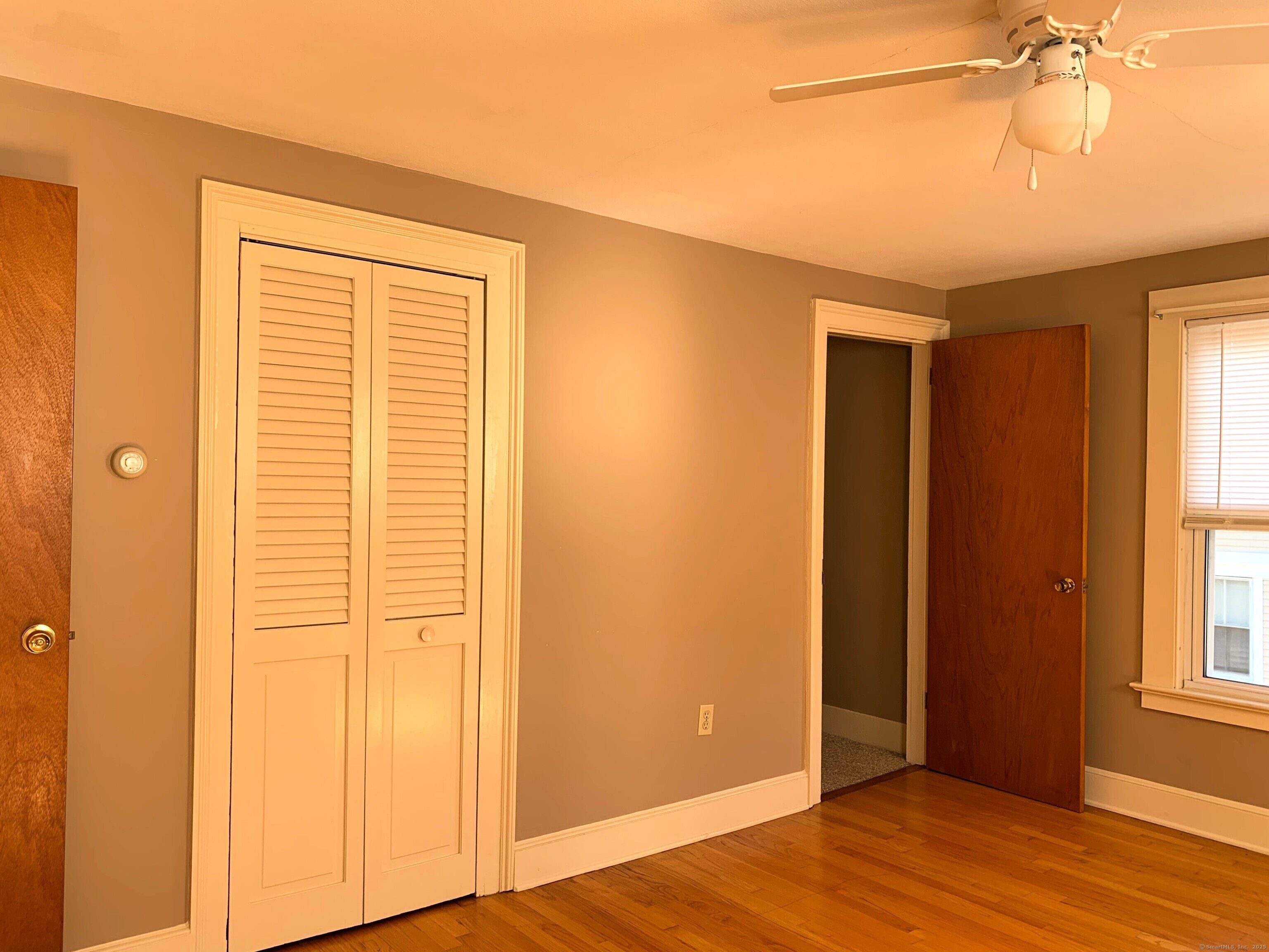 96 Main Street, Unit 2 Branford, CT 06405 - Photo 6 of 10 a view of empty room with wooden floor and fan
