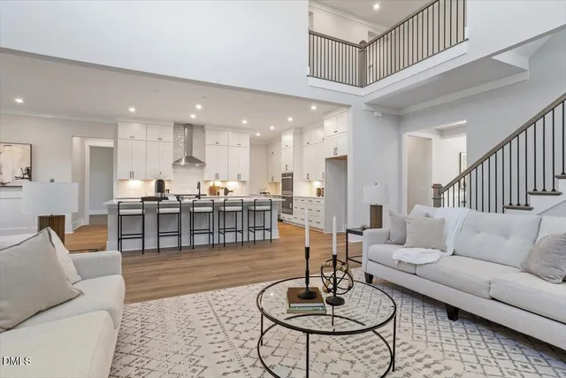 a kitchen with granite countertop a table chairs sink and cabinets