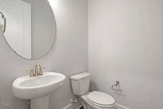 a bathroom with a sink toilet vanity and shower
