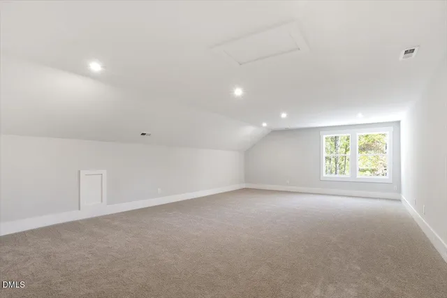 a room with a table chairs and a refrigerator