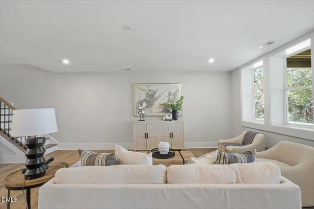 a view of a big room with wooden floor and windows