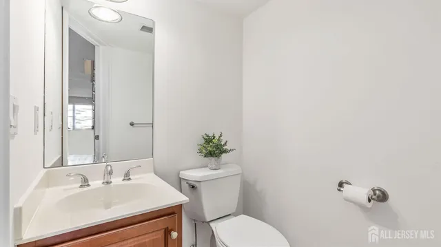 a bathroom with a sink mirror and toilet