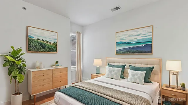 a bedroom with a bed and a potted plant