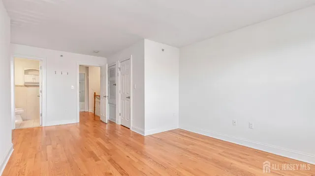 a view of a room with wooden floor