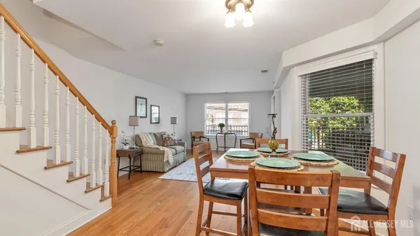 a view of a dining room with furniture window and wooden floor