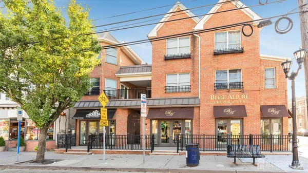 a view of a brick building with a tree