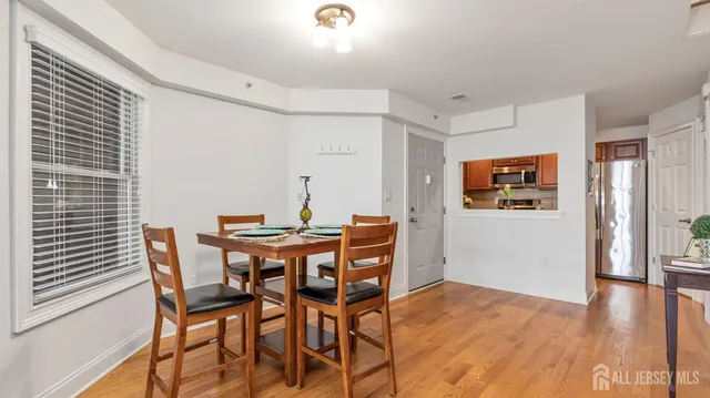 a view of a dining room with furniture and wooden floor