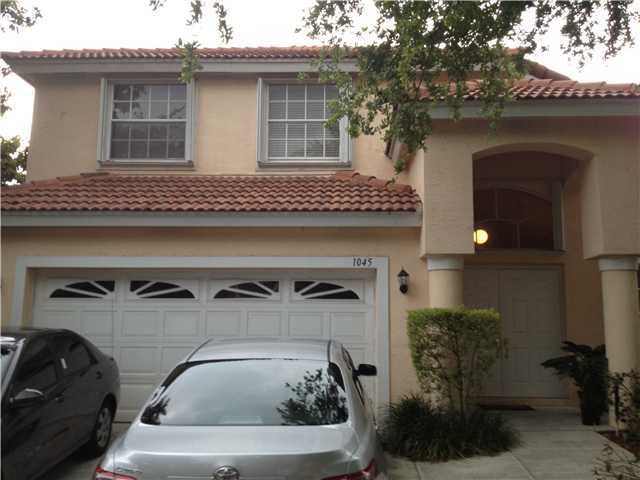 1045 Aspri Way Riviera Beach, FL 33418 - Photo 1 of 19 a view of car parked in garage