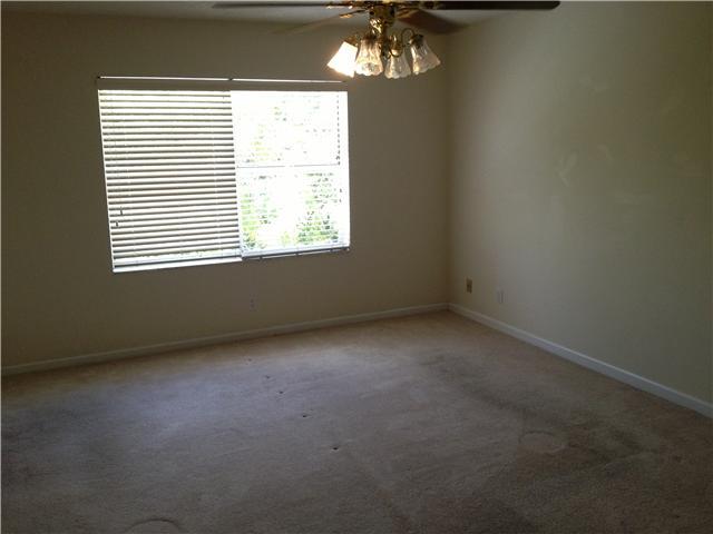 1045 Aspri Way Riviera Beach, FL 33418 - Photo 7 of 19 an empty room with a windows and chandelier