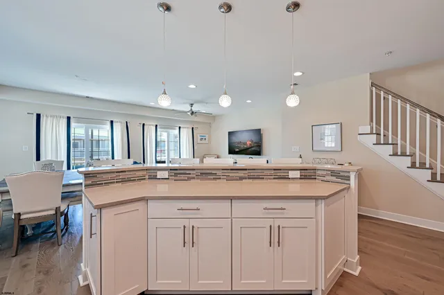 a kitchen with center island table and chairs
