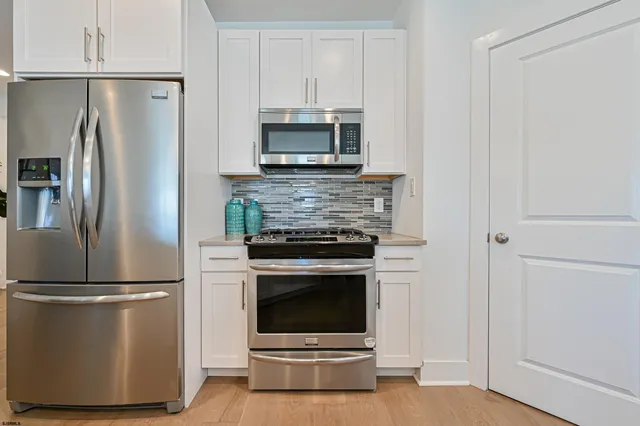 a kitchen with appliances and cabinets