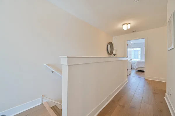 a view of a hallway with wooden floor