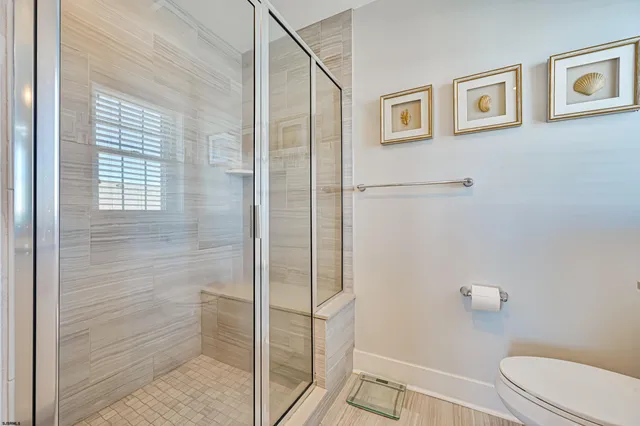 a bathroom with a toilet and a shower