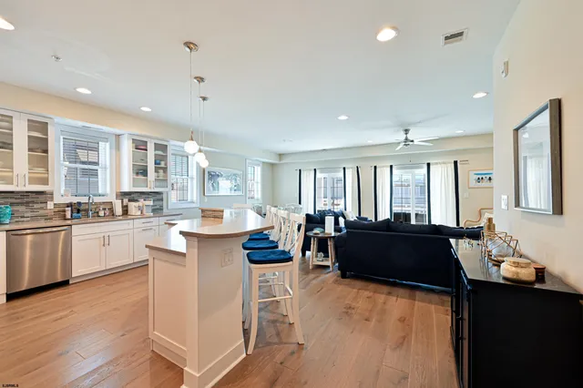a living room with kitchen island granite countertop furniture and a large window