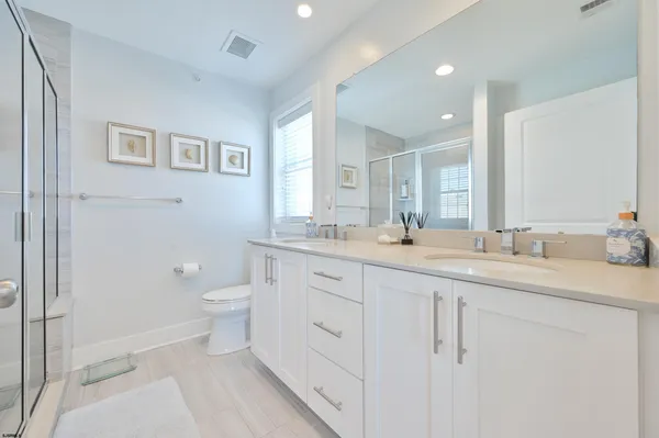 a spacious bathroom with a granite countertop sink mirror and toilet