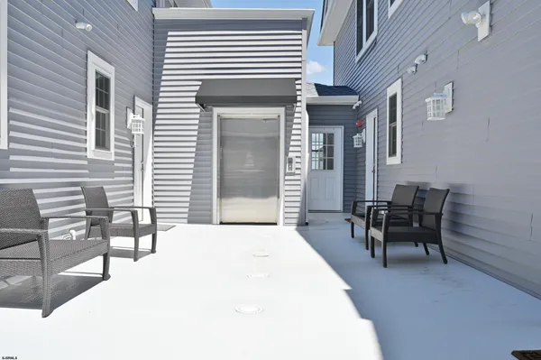 a backyard of a house with outdoor seating