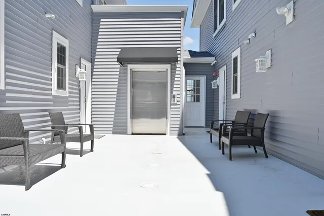 a backyard of a house with outdoor seating