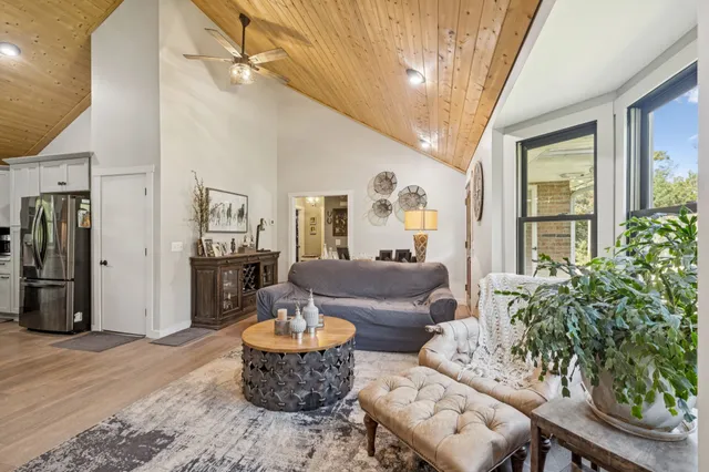 a view of a dining room with furniture and a potted plant