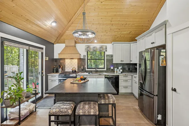 a kitchen with a table chairs and refrigerator