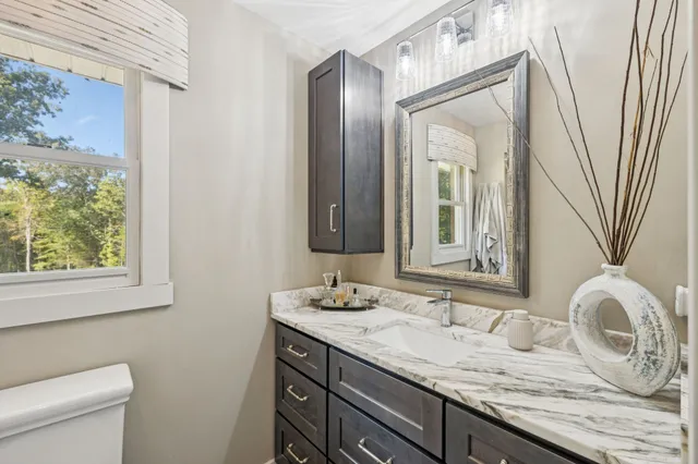 a bedroom with a bed and a painting on the wall