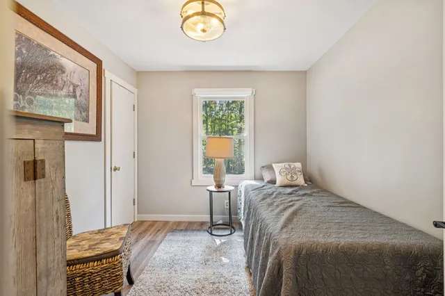 a bathroom with a granite countertop sink mirror vanity and toilet