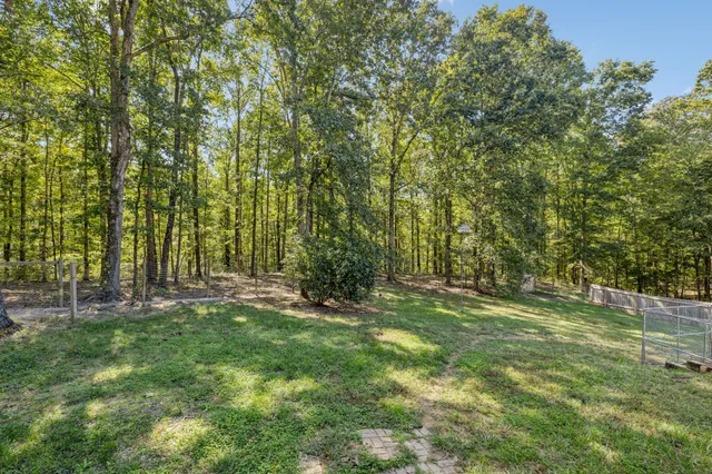 a view of a table and chairs in patio with wooden fence