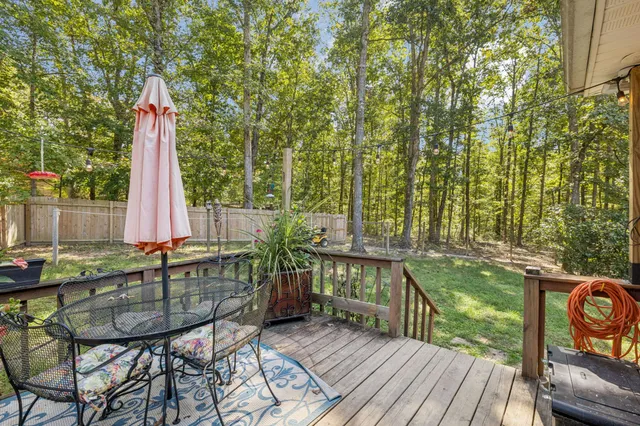 a view of a chairs and table on the roof deck