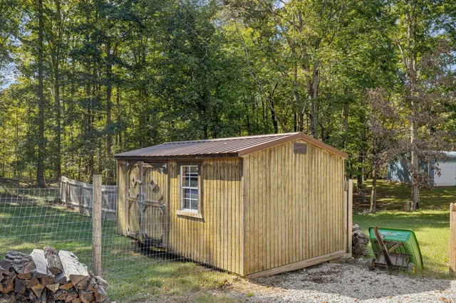 an aerial view of residential houses with outdoor space and trees