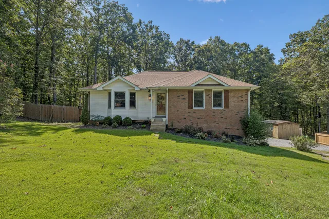 a front view of a house with a garden