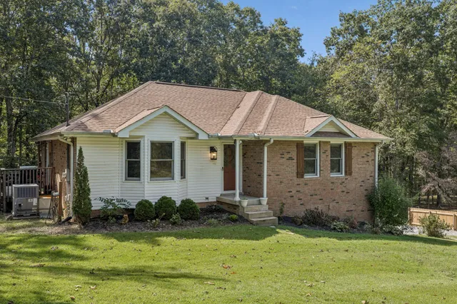 a aerial view of a house with swimming pool next to a yard