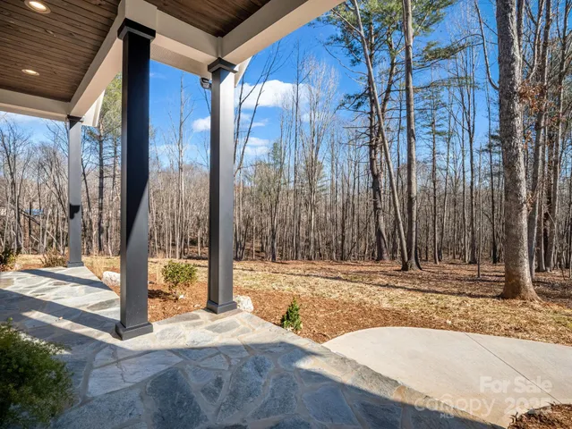 a view of empty room with a fireplace and window
