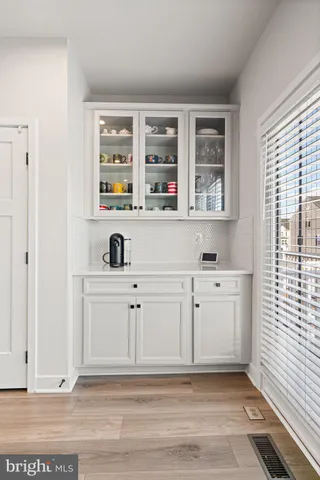 a kitchen with refrigerator a sink and chairs