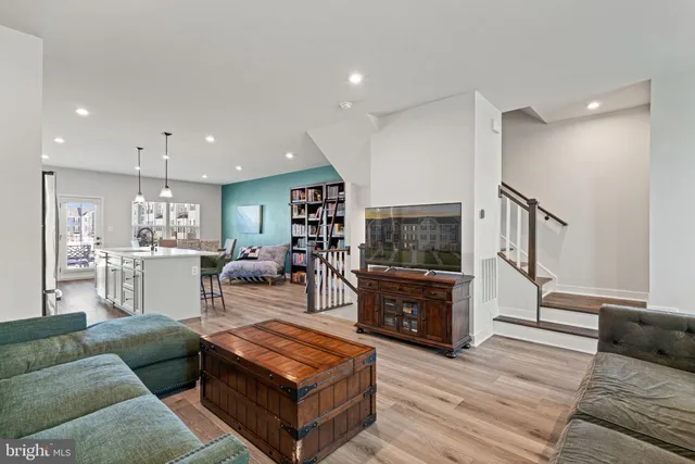 a living room with furniture and view of kitchen