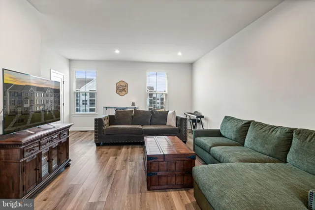 a view of a livingroom with wooden floor and stairs