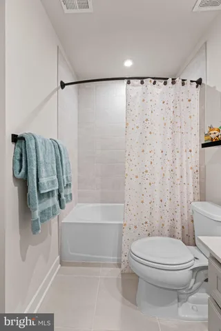 a bathroom with a sink a mirror and a painting on the wall