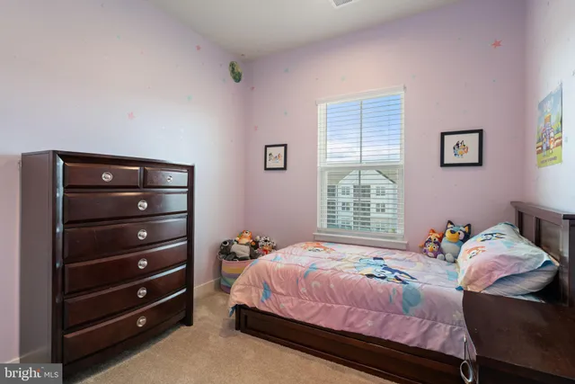 a bedroom with a bed and a cabinet