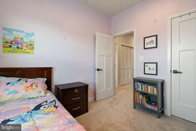 a bedroom with a bed and a dresser