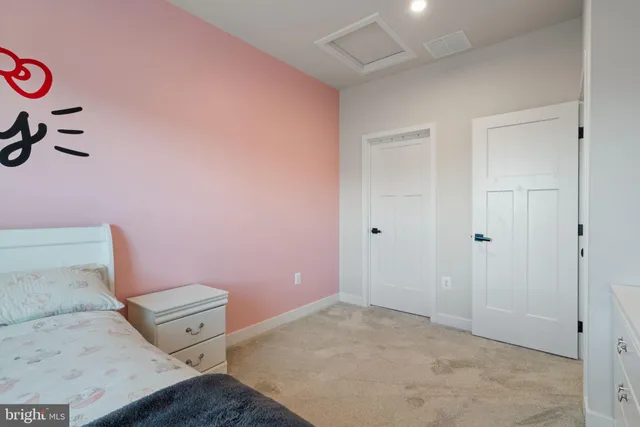 a view of a hallway with a door and furniture