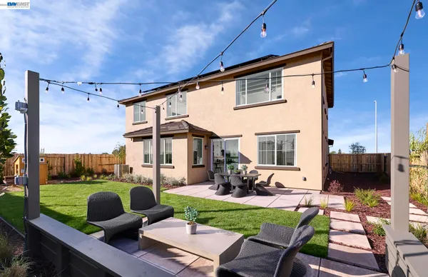 a front view of a house with garden and patio