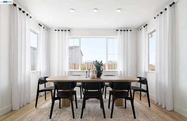 a view of a dining room with furniture and window