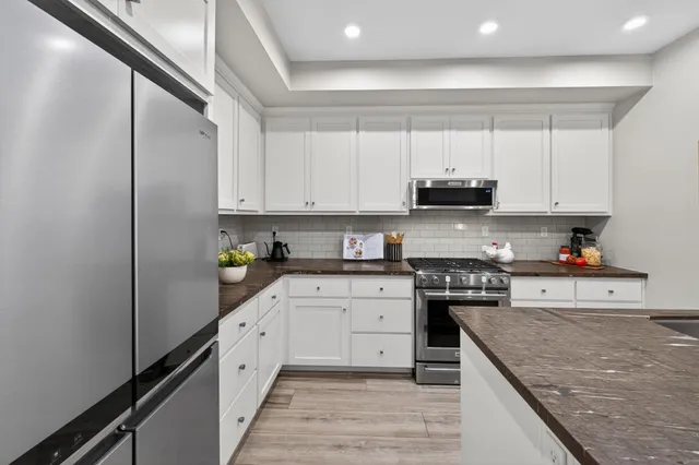 a close view of a utility room with dryer and washer