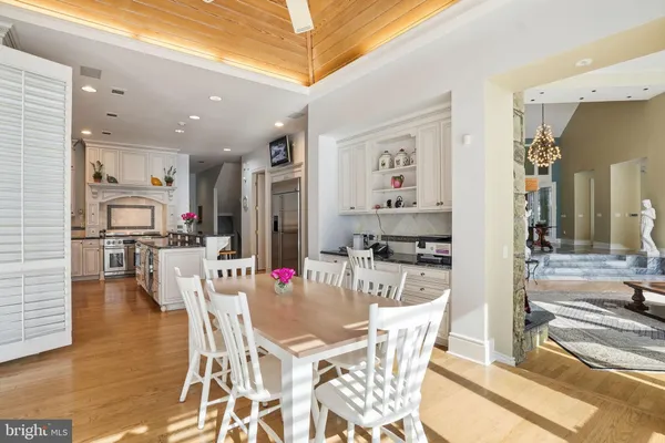 a kitchen with granite countertop white cabinets and stainless steel appliances