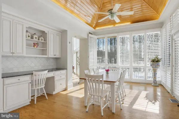 a dining room with furniture and wooden floor